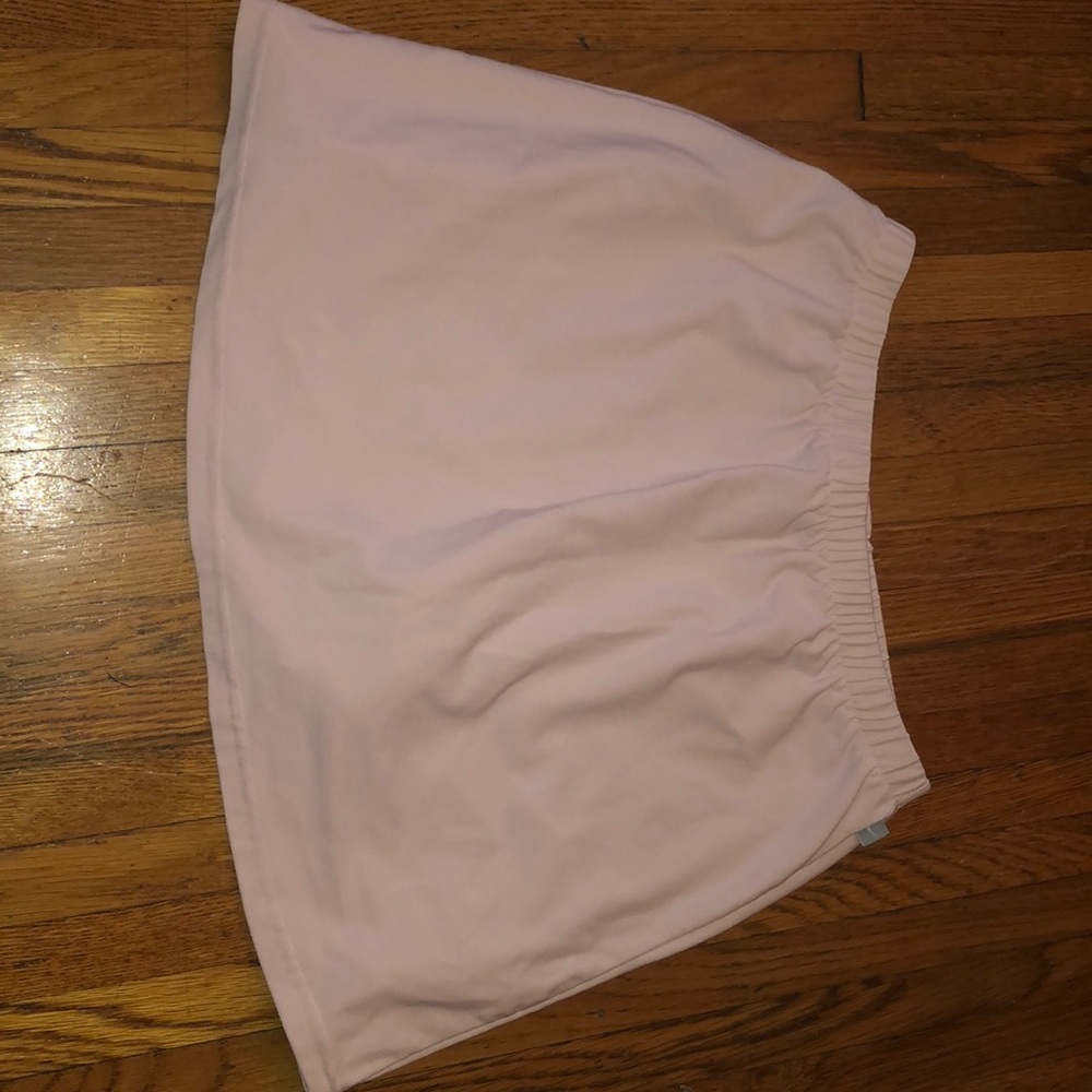 light pink nike skirt w/ compressions underneath.
